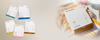 Cinque box Maraes Travel Kit accanto a una box Curly Care su un asciugamano e una borsa in rete