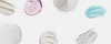 Haircare product textures including cream, gel, foam, powder, and serum arranged on a light background with open space in the center for banner content.