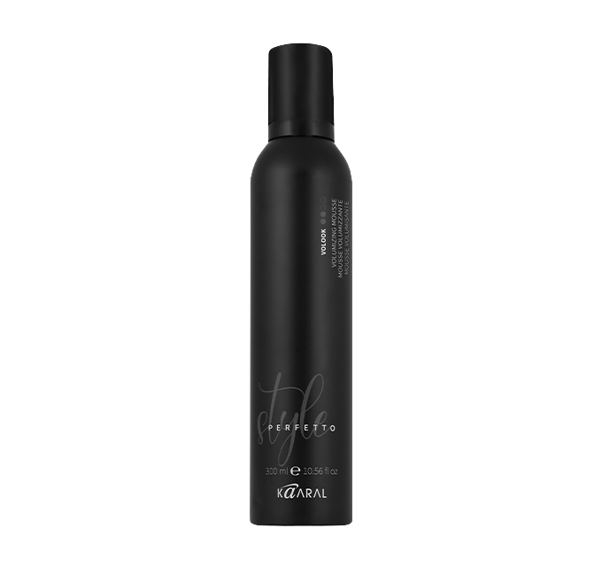 Tall black haircare bottle on a black background