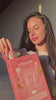 Woman holding a pink Purify Volume product box